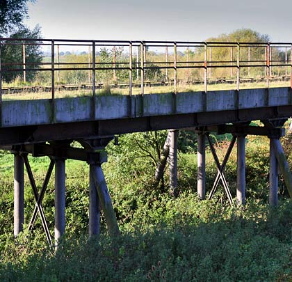 The approach viaduct rises up on neatly braced piers.