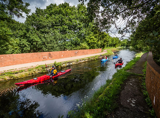 Canoeists navigate the canal over the aqueduct.
