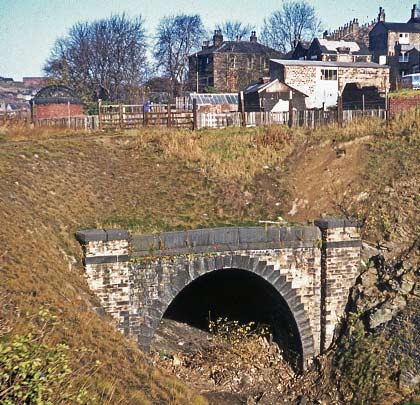 In November 1973, although the tracks have been lifted, the southern portal of the tunnel remains unburdened by landfill.