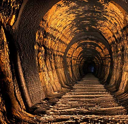 Water-borne minerals have 'glued' the remaining ballast together. Collars of brickwork serve as evidence of regular repair works.