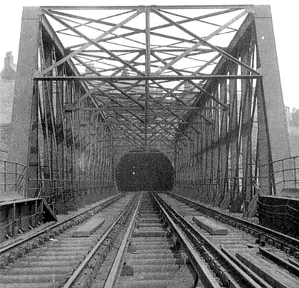 Pictured in the 1930s, a lattice girder bridge carried trains to the western portal of the tunnel.