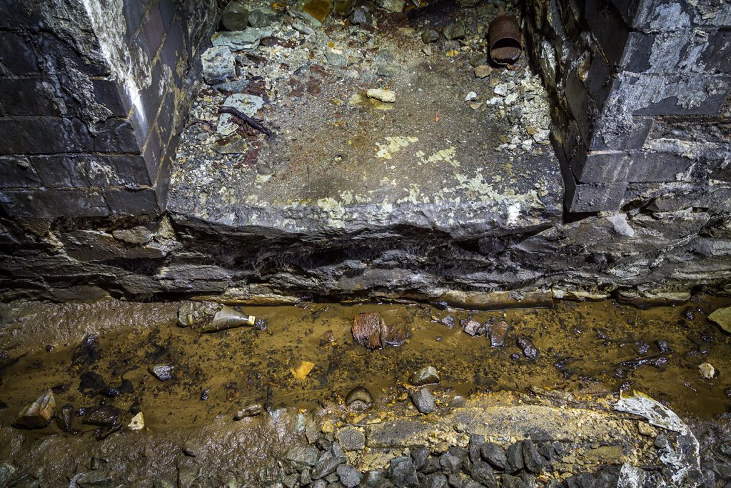 An open drain runs at the toe of the sidewall.
