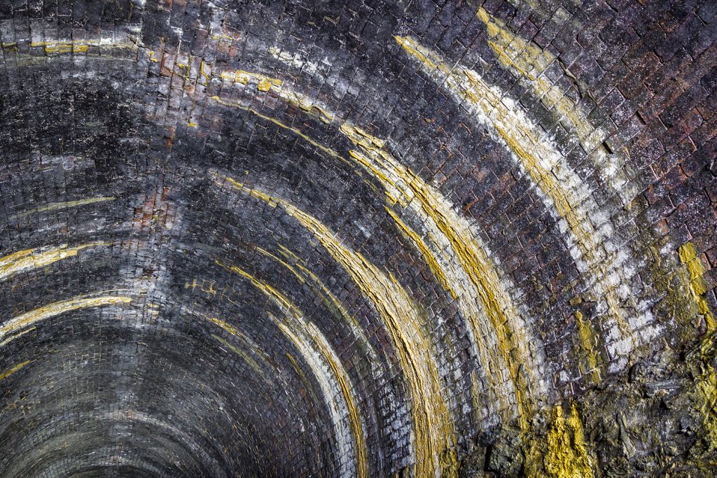 Water ingress, with calcite deposits, is apparent at locations along the tunnel.